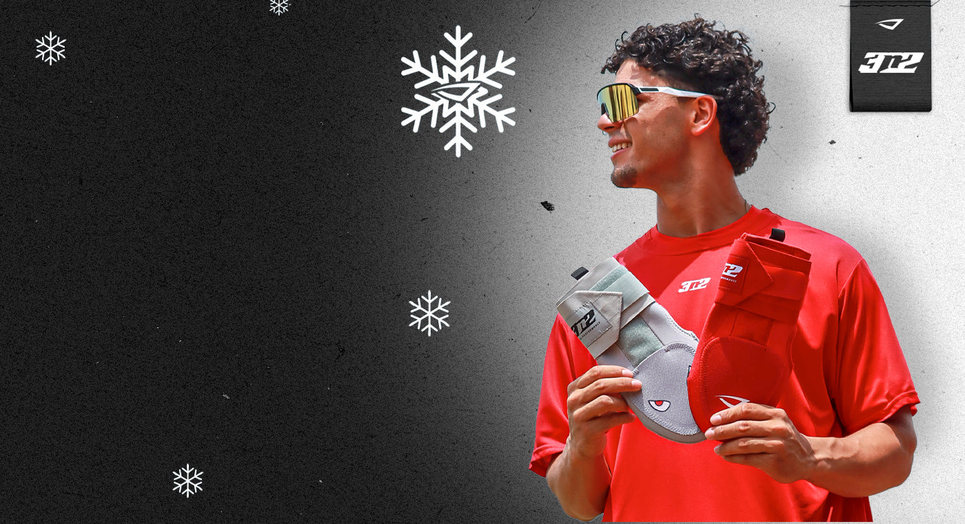 Athlete holding sliding mitts with snowflake graphics and a brand logo on a dark background